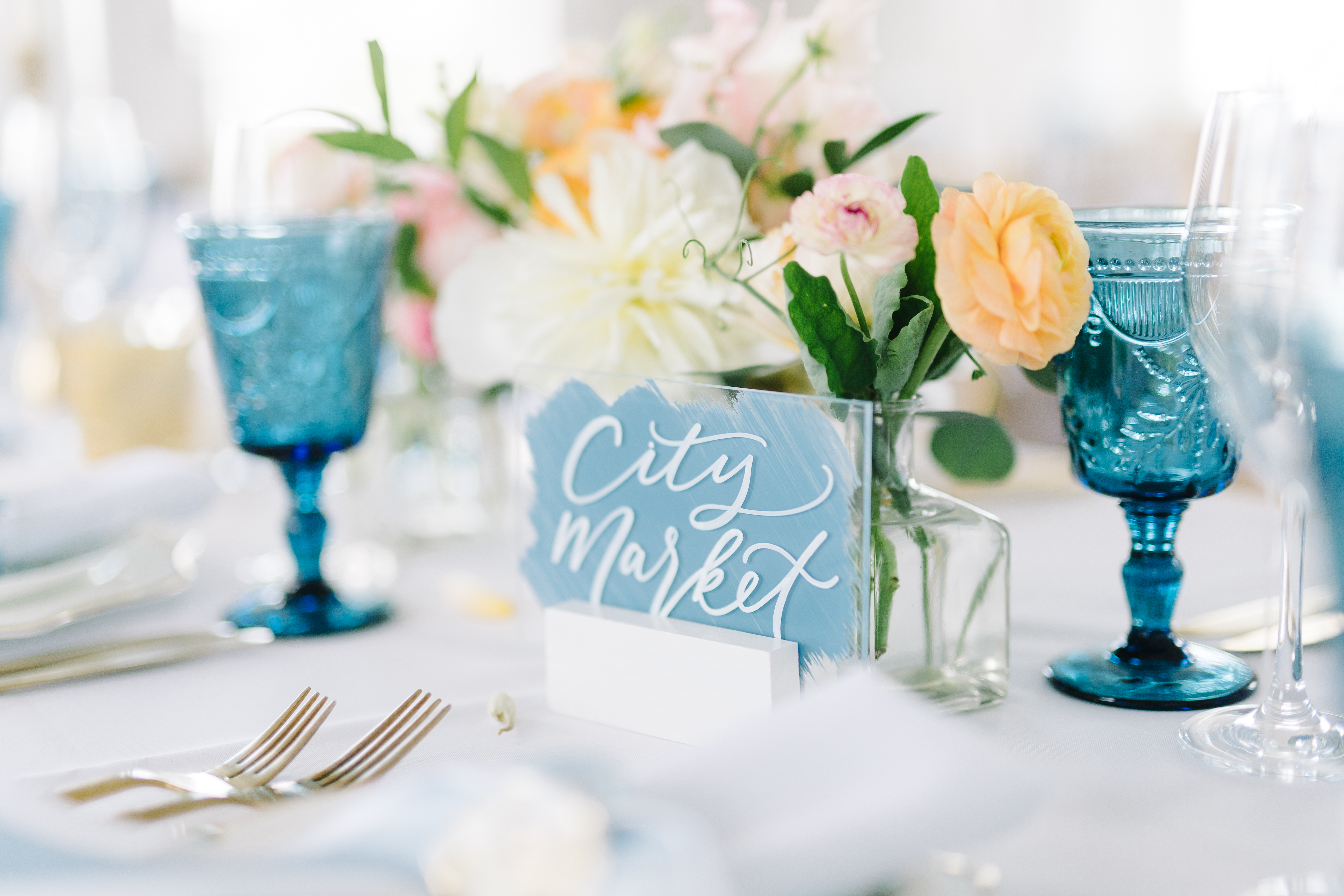 Calligraphed reception table names on acrylic. Blue and white wedding reception decor