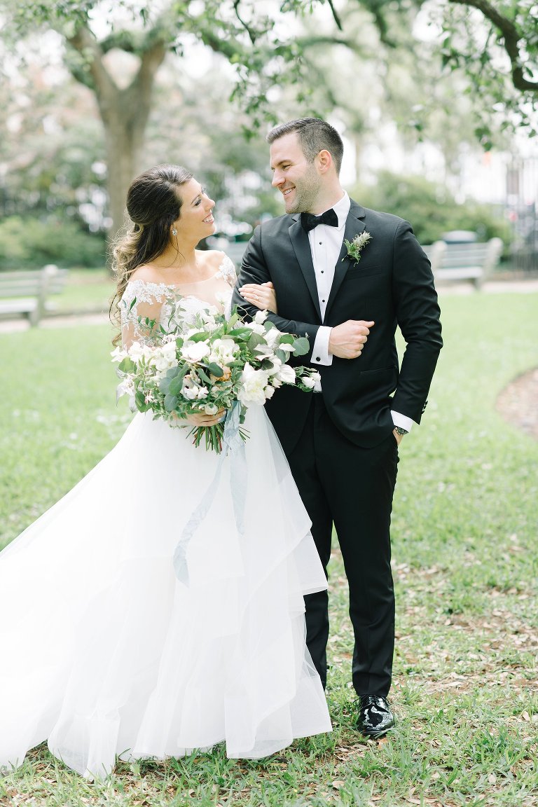 Bride and groom in downtown Charleston.  Black tie wedding.  Wedding gown with lace sleeves