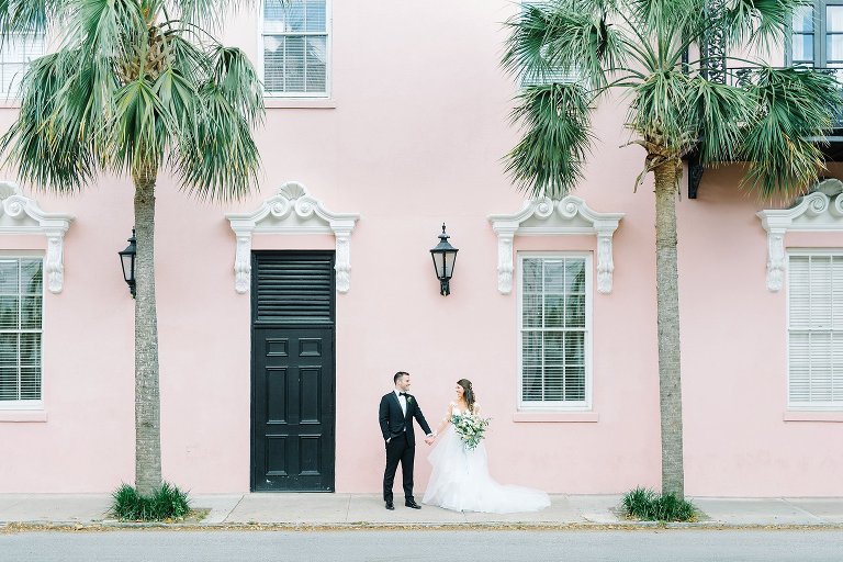 Bride and groom in downtown Charleston.  Black tie wedding.  Wedding gown with lace sleeves