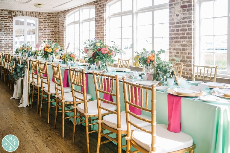 Tate and Davis's Historic Rice Mill Wedding by Charleston wedding photographers Aaron and Jillian Photography - Charleston Stems, reception decor, Southern wedding reception, gold chiavari chairs, mint linens, pink, yellow, white florals,