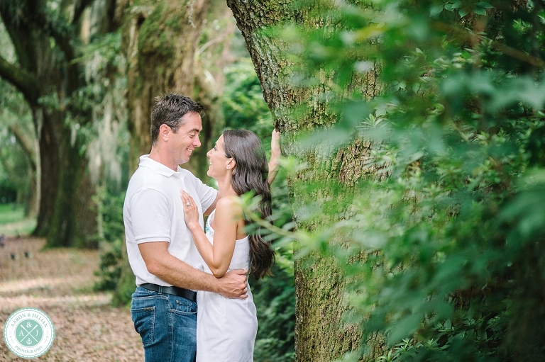 Couple in the Avenue of Oaks at The Legare Waring House. Engagement photos by Charleston wedding photographers Aaron and Jillian Photography